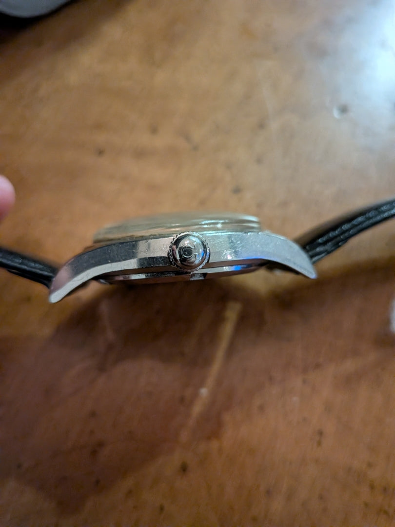 Omega - silver, black strap, arrow head dial