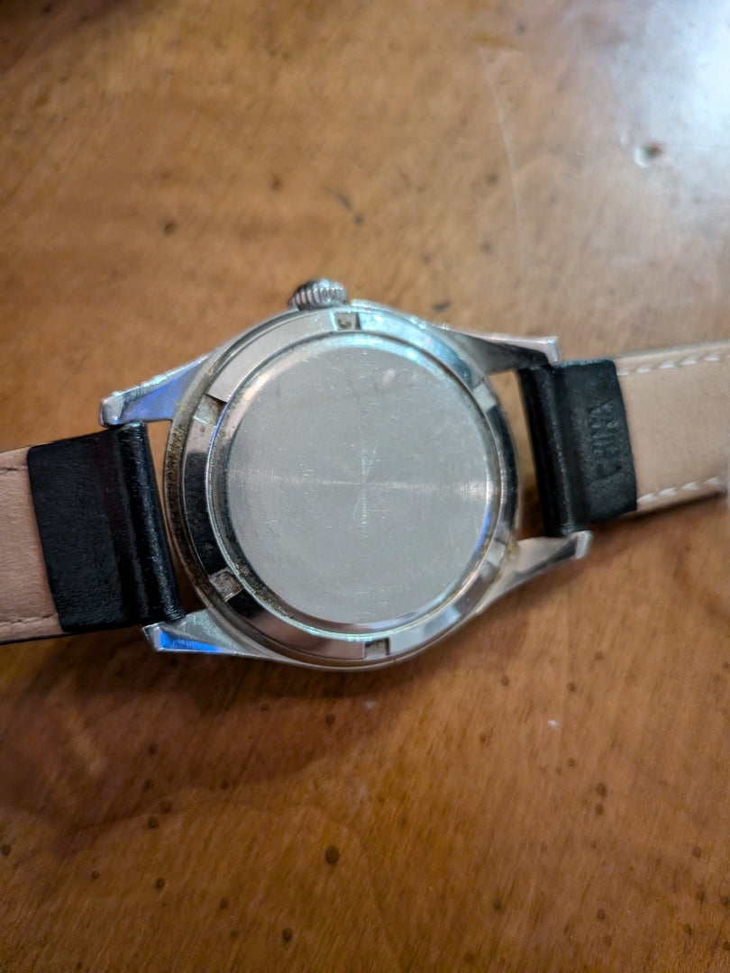 Omega - silver, black strap, arrow head dial