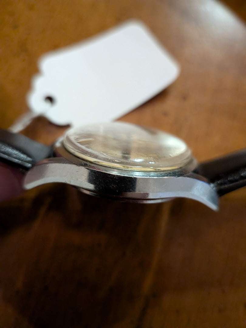 Omega - silver, black strap, arrow head dial